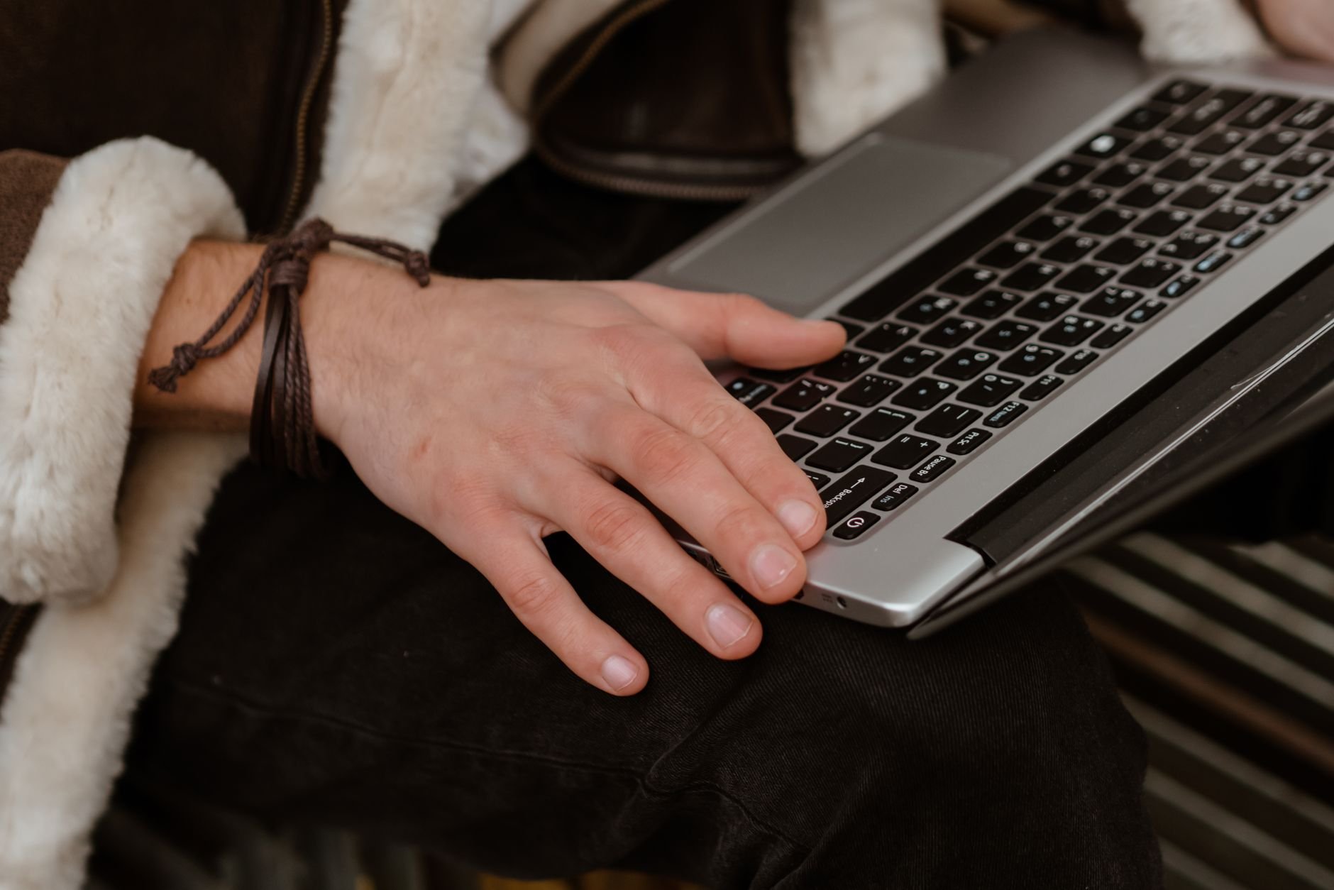 Person using a laptop, embodying freelance work and independent productivity.